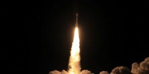 Rocket launching into a starry sky.