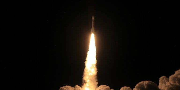Rocket launching into a starry sky.